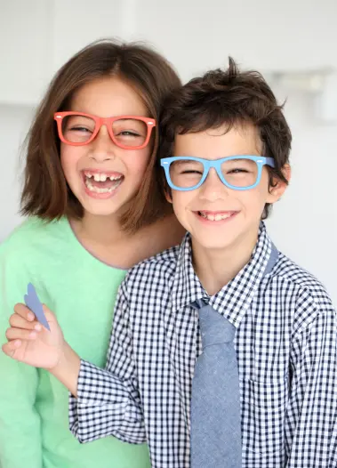 niños con lentes y sonriendo